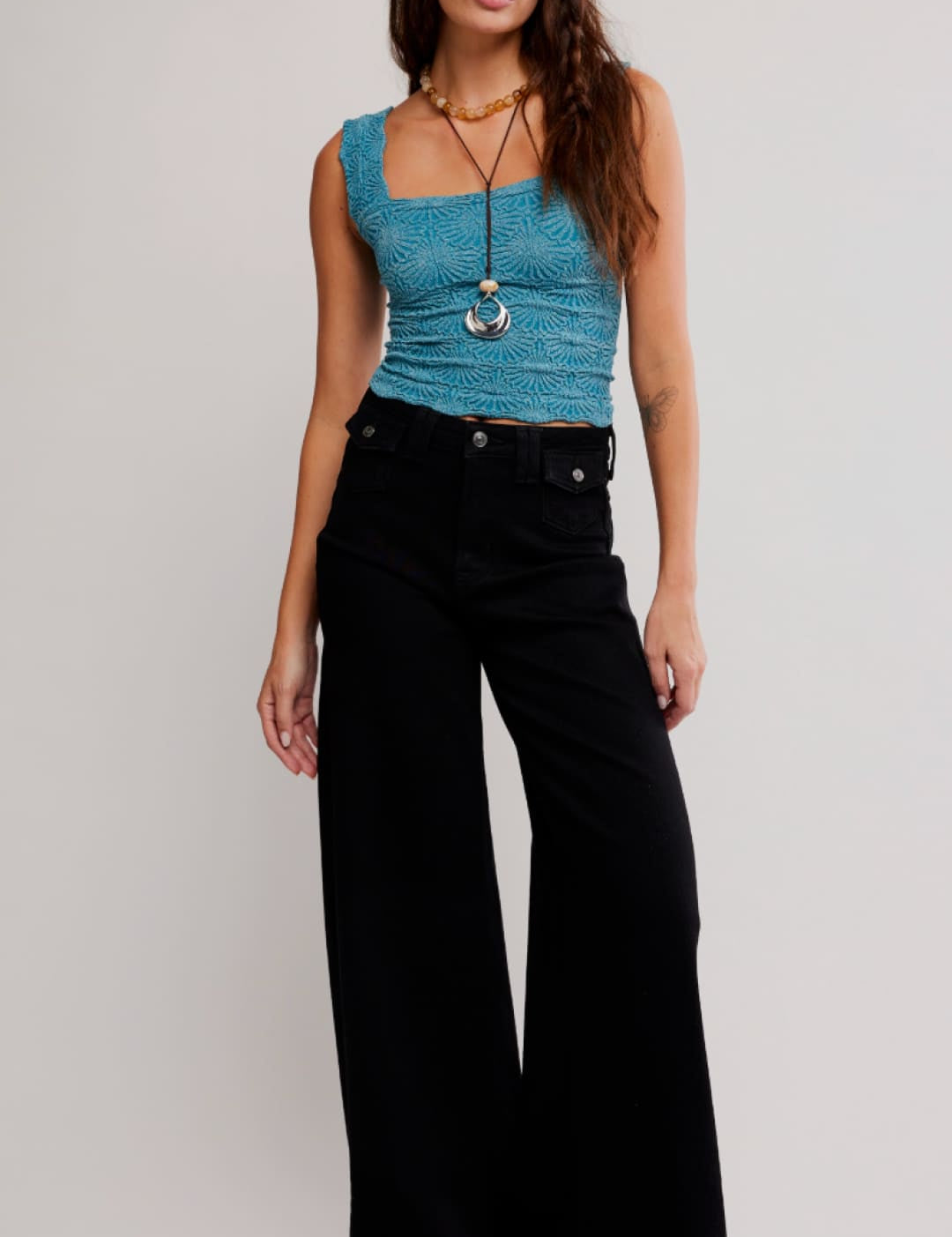 A teal, textured sleeveless crop top with a square neckline.