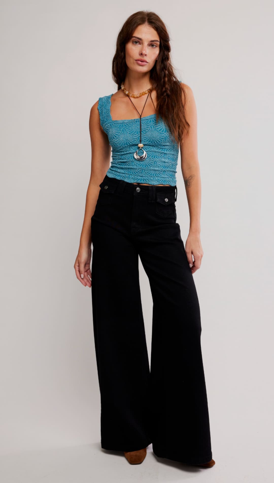 A teal, textured sleeveless crop top with a square neckline.