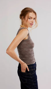 A textured, taupe-colored knit sleeveless top with a subtle radial pattern.