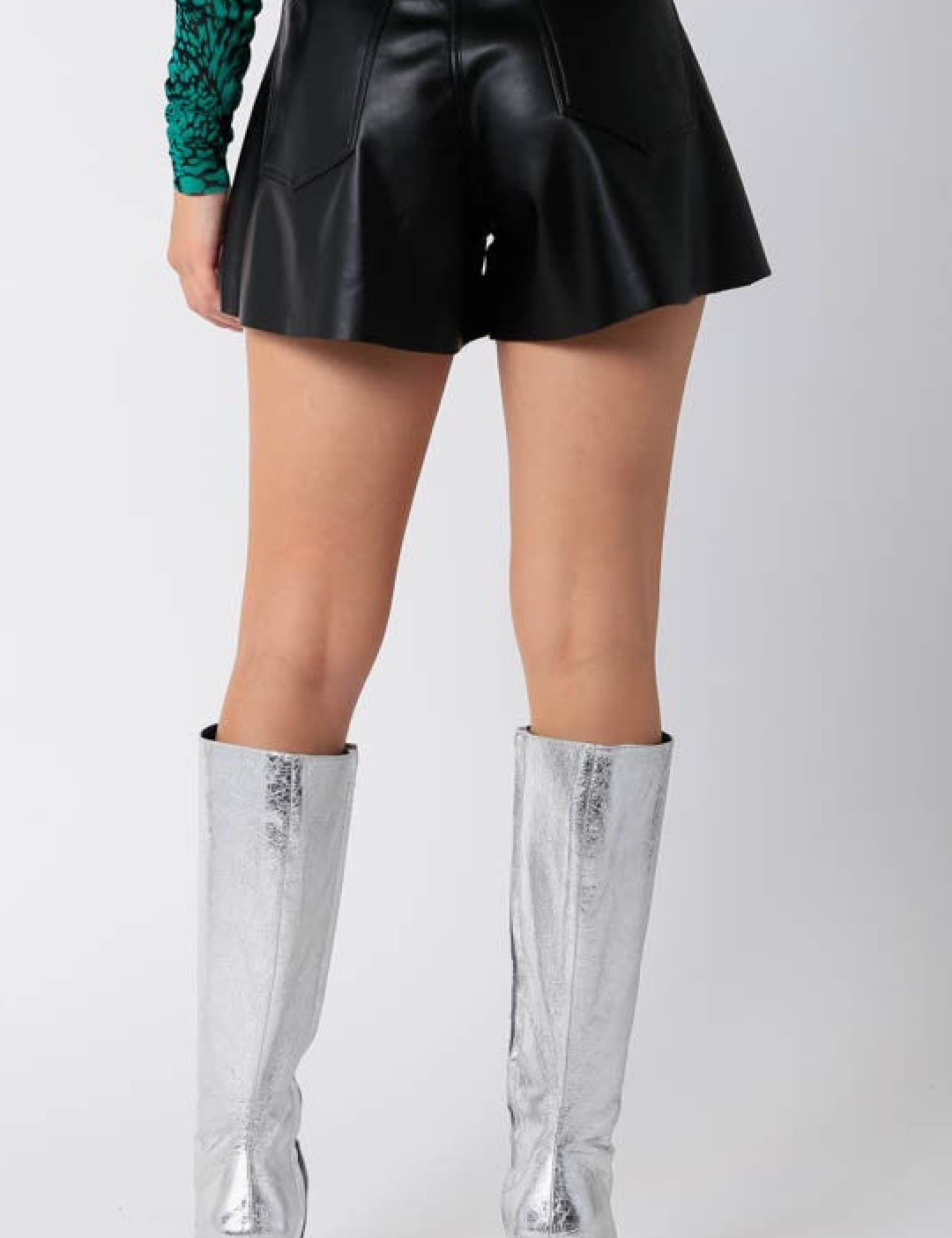 Black faux leather flared shorts with a high waist.