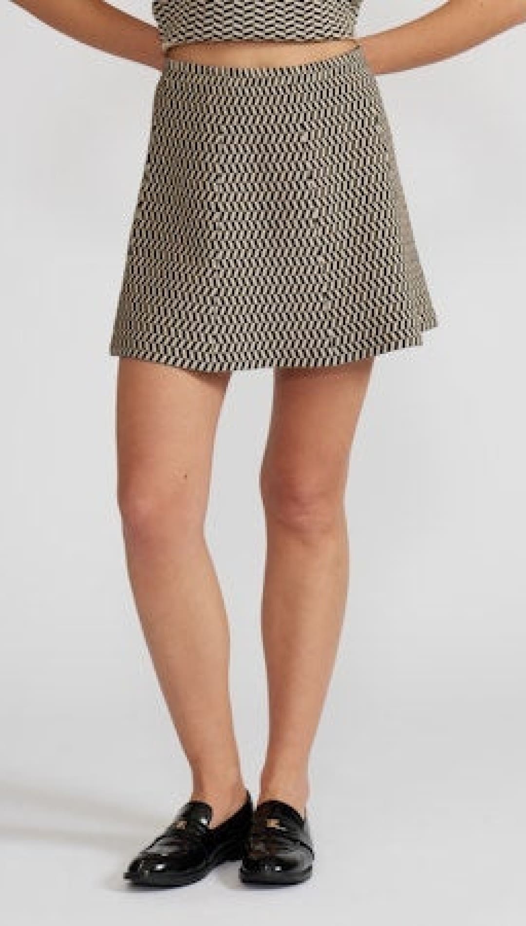 A-line mini skirt with a black and beige geometric wave pattern.