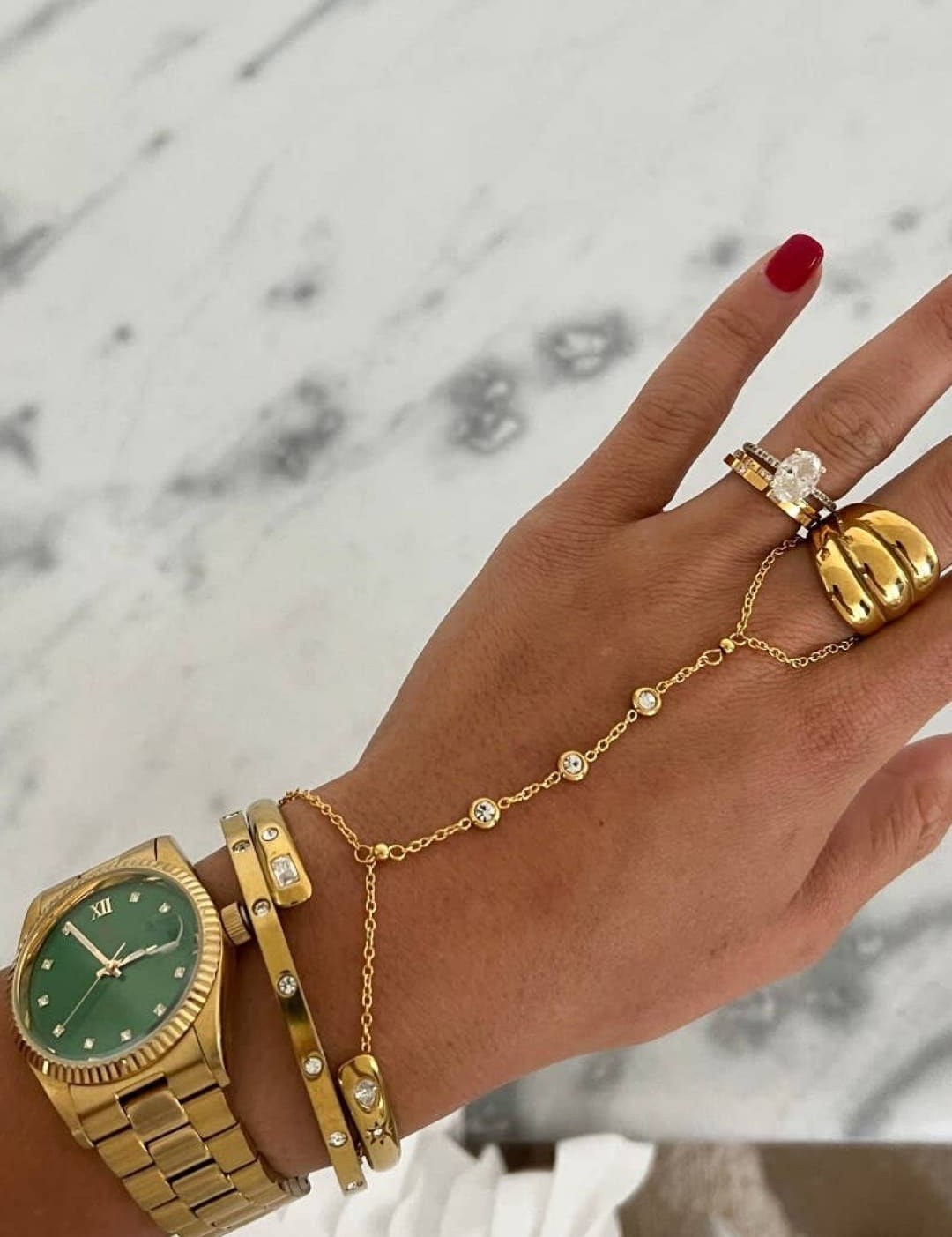 Gold-tone wristwatch with a green dial and diamond accents on the bezel, featuring a classic link bracelet design.