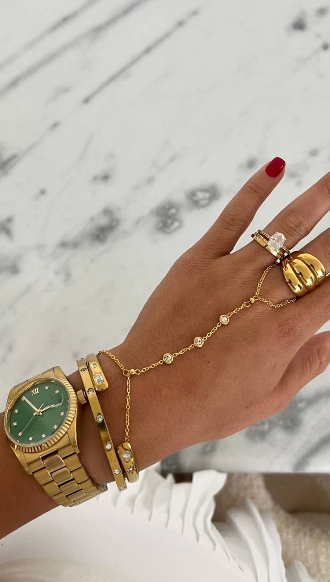 Gold-tone wristwatch with a green dial and diamond accents on the bezel, featuring a classic link bracelet design.