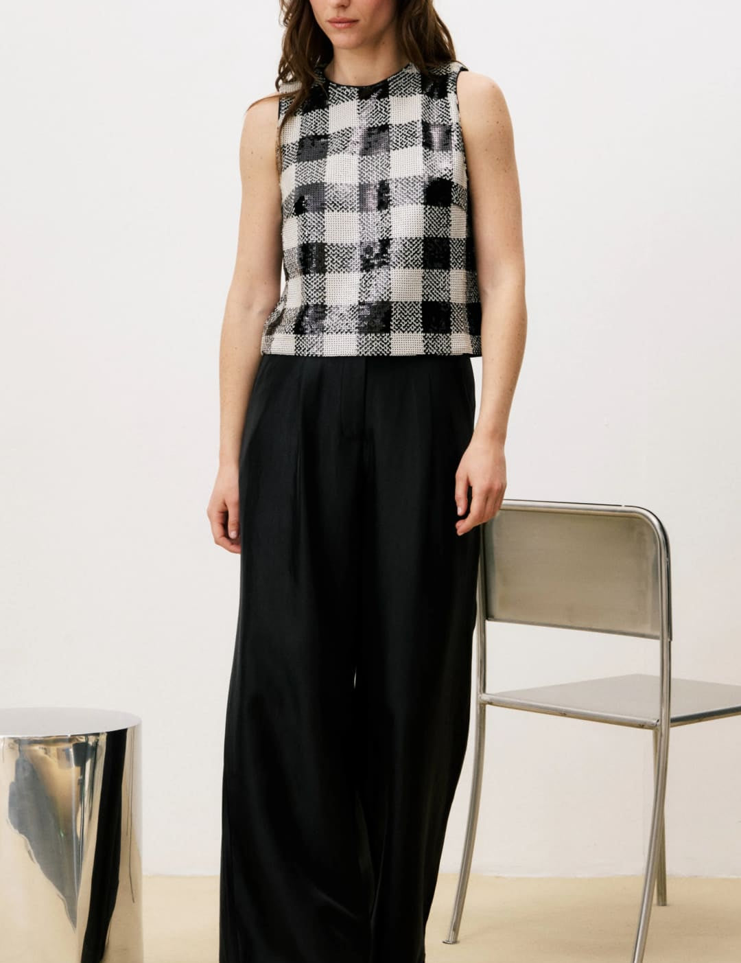 Black and white plaid sleeveless top with wide-leg pants.