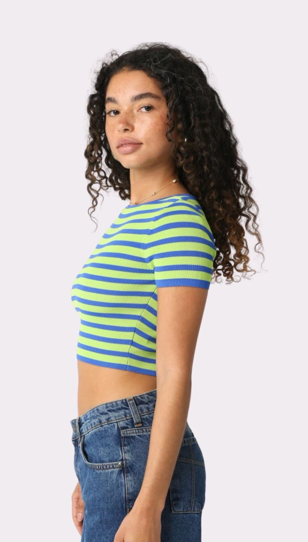 Woman wearing a striped crop top.