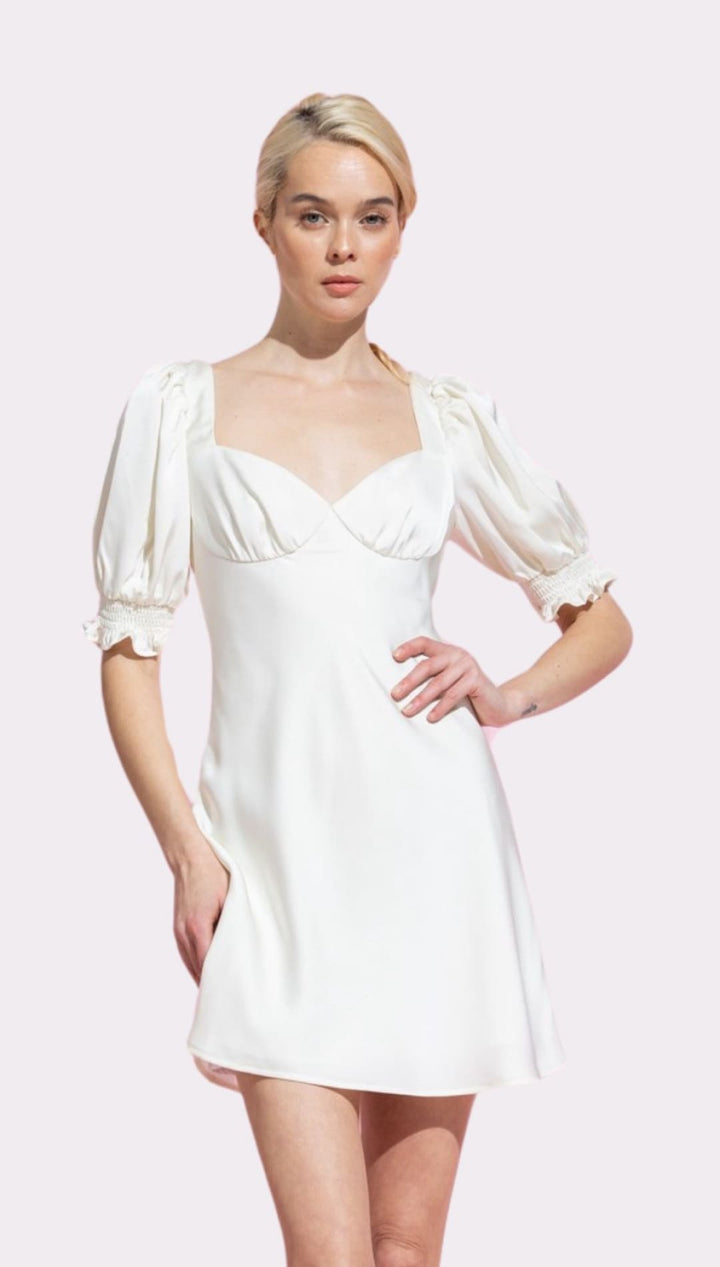 White satin mini dress with puff sleeves.