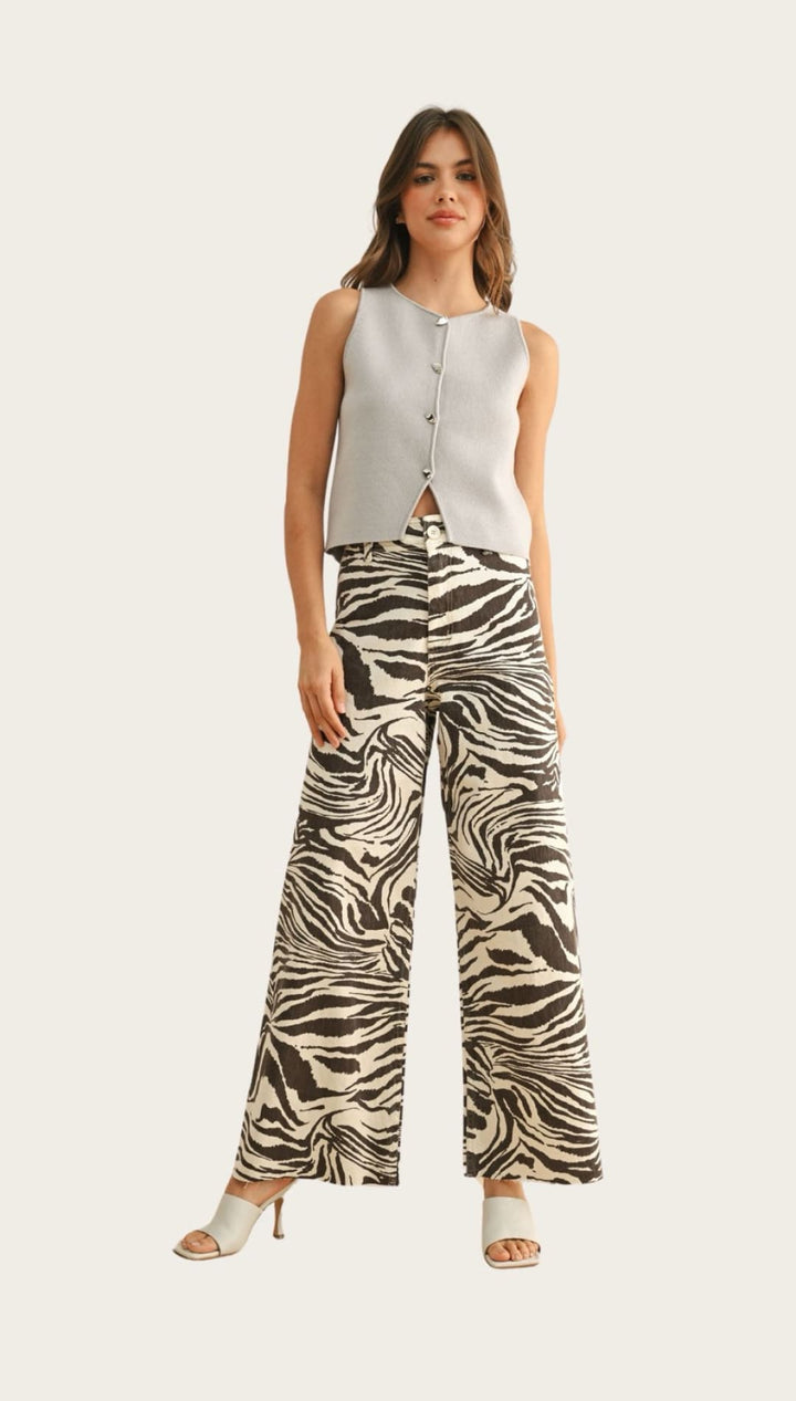 Woman wearing zebra-print pants and a light-blue top.