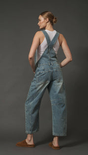 Denim overalls with adjustable straps and pockets, light blue wash.