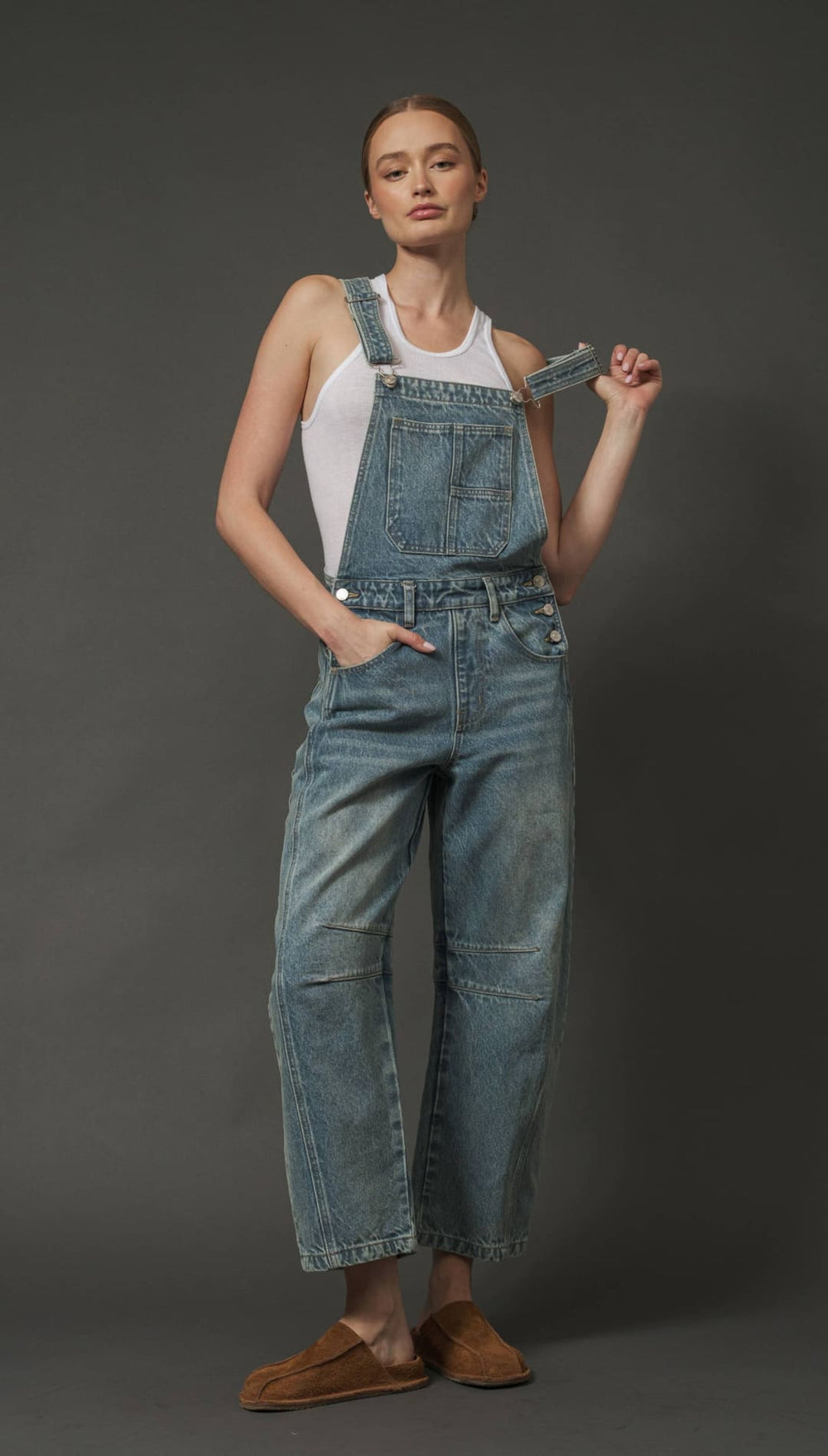 Denim overalls with paperbag waist and patch pockets, brown suede moccasins.