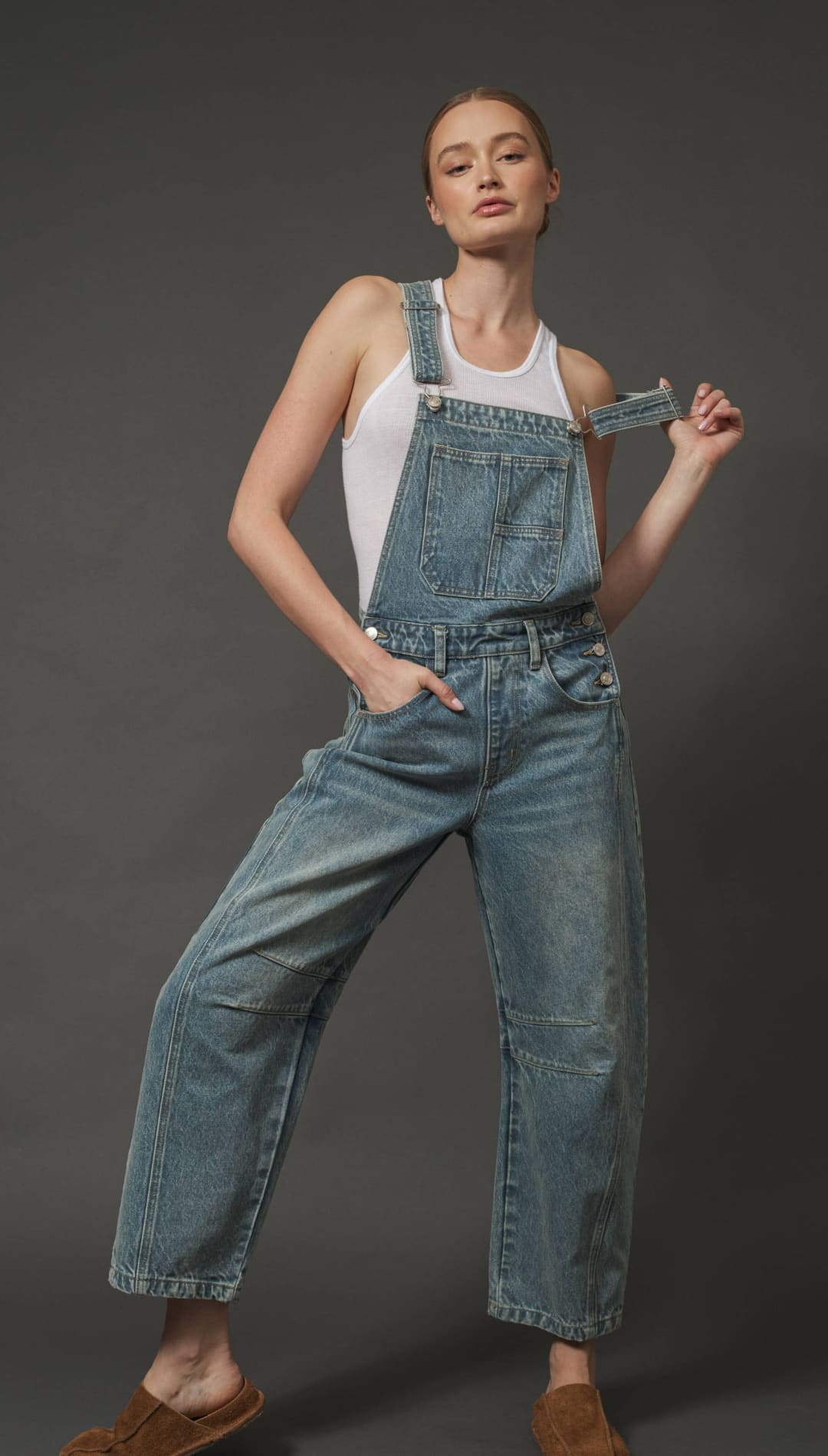 Denim overalls with a relaxed fit and adjustable straps.