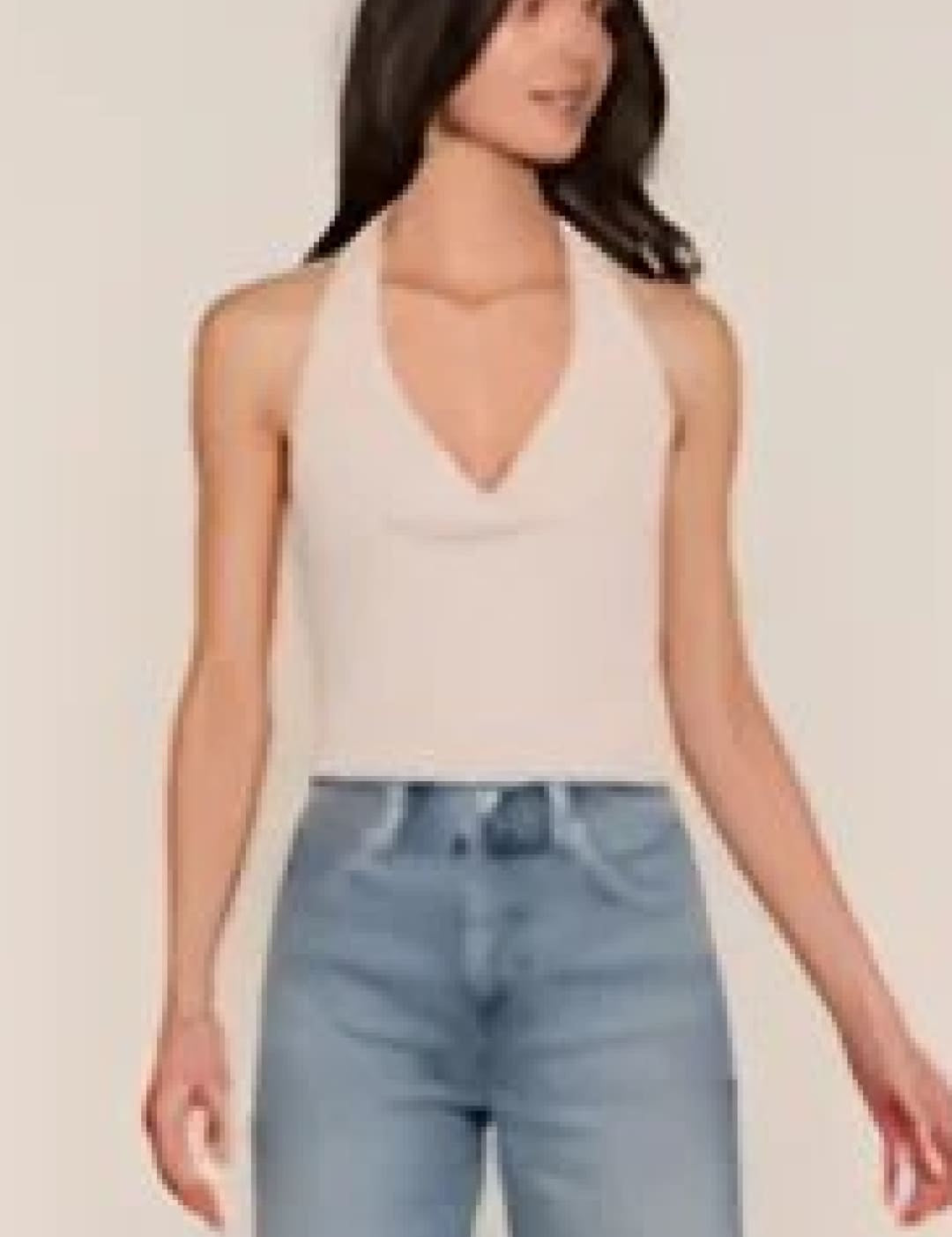 Beige sleeveless top with a v-neck and thin straps.