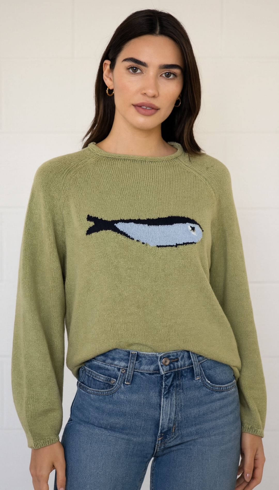 Women’s olive green long-sleeved sweater with a light blue fish graphic.