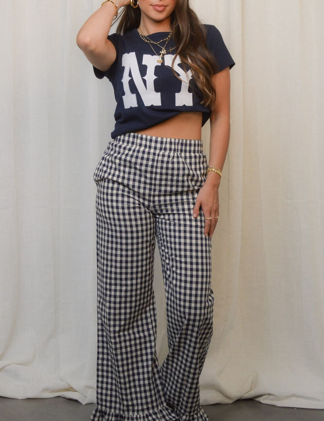 Women’s black and white gingham wide-leg pants with ruffled hems.