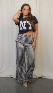 Women’s black and white gingham wide-leg pants with ruffled hems.