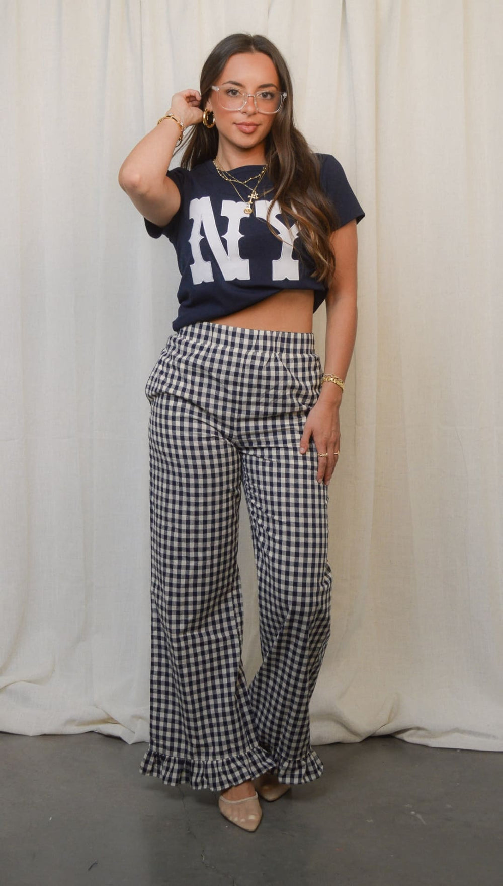 Women’s black and white gingham wide-leg pants with ruffled hems.
