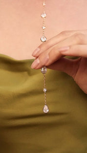 Delicate gold chain with sparkling crystal pendants.