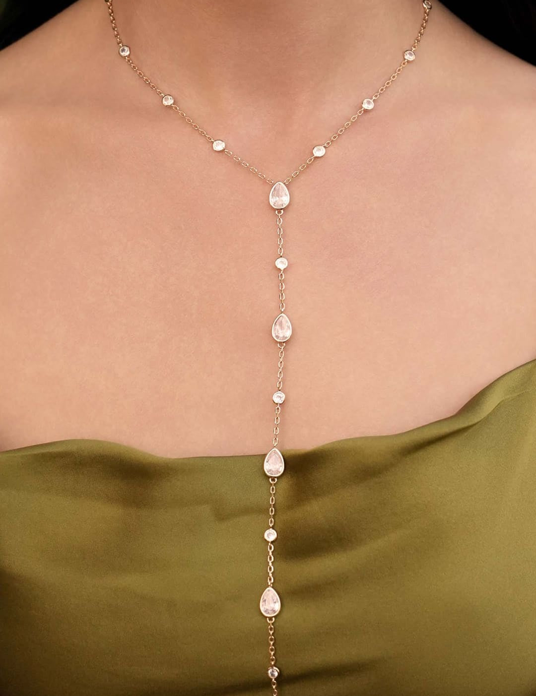 Gold-toned necklace with teardrop and round crystals.