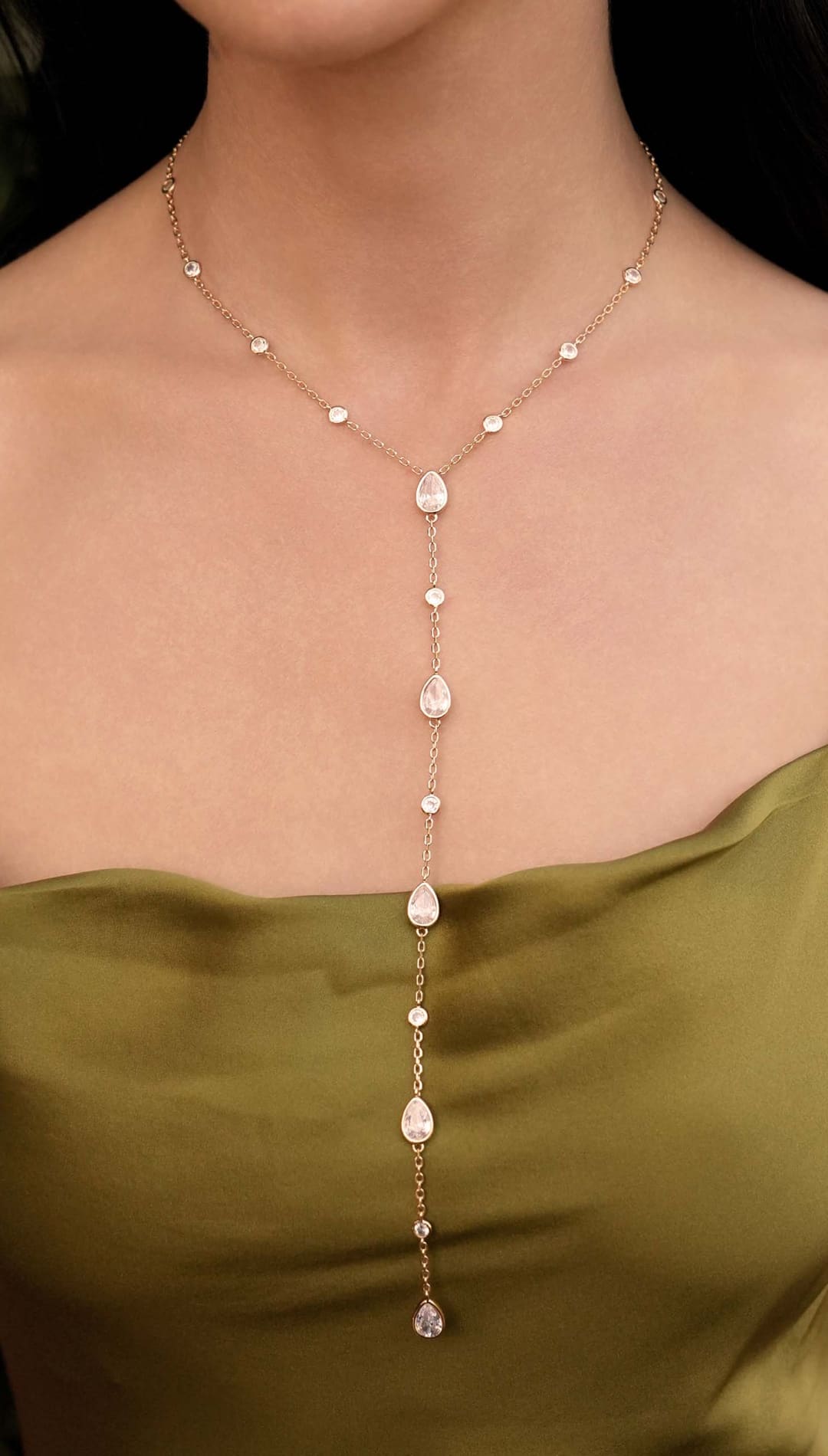 Gold-toned necklace with teardrop and round crystals.