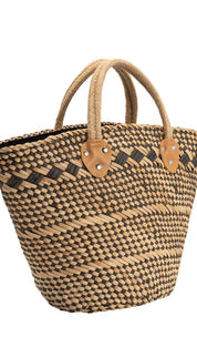 A woven straw tote bag with natural and dark brown stripes, featuring tan leather handles and accents.