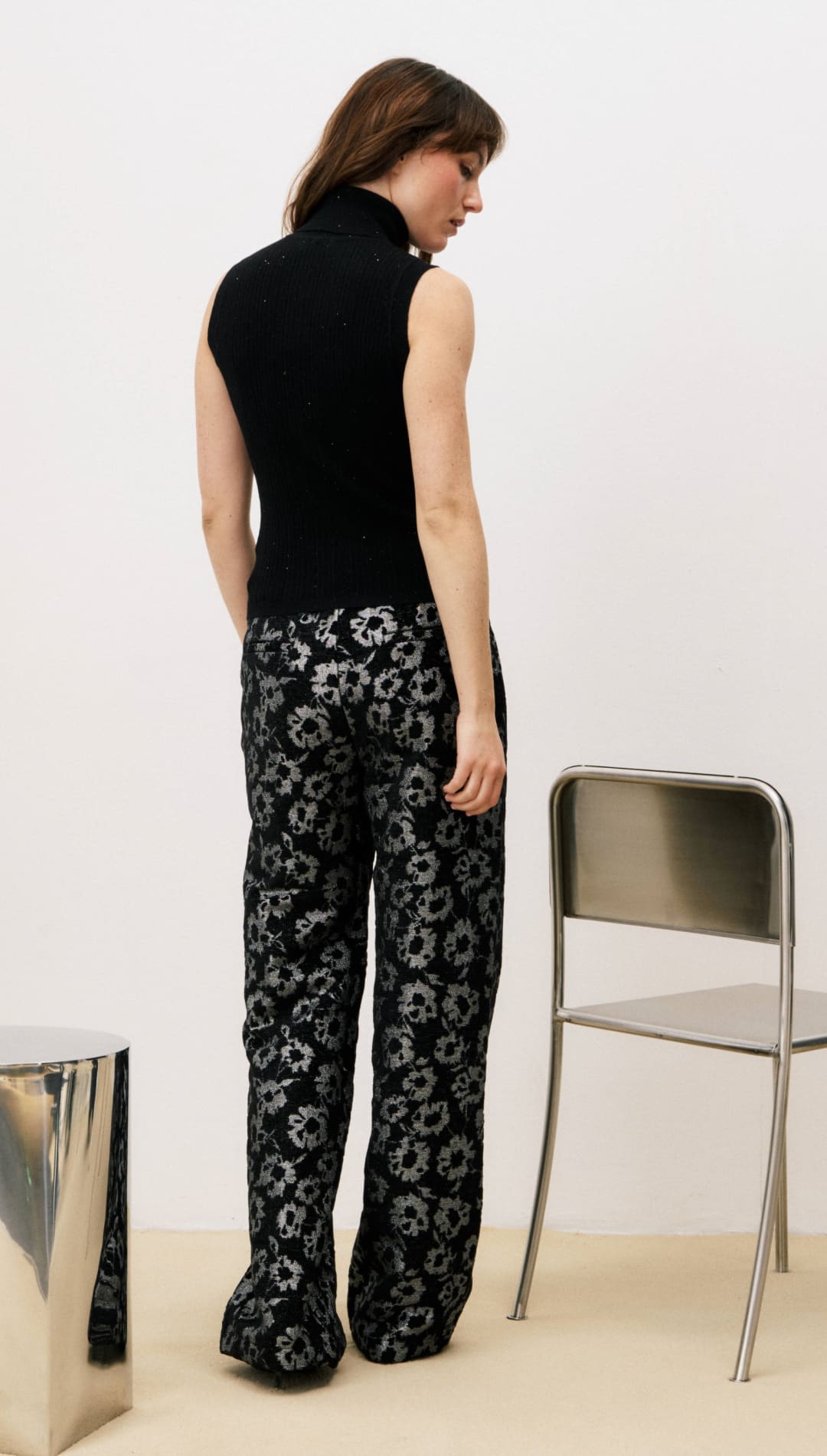 Black floral print wide-leg pants with silver metallic accents.