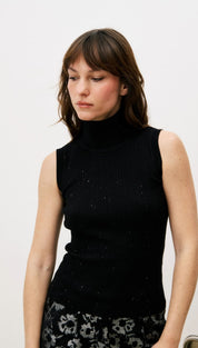 Black sleeveless turtleneck sweater with subtle glitter details.
