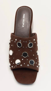 Brown free people slide sandal with silver eyelets and studs.