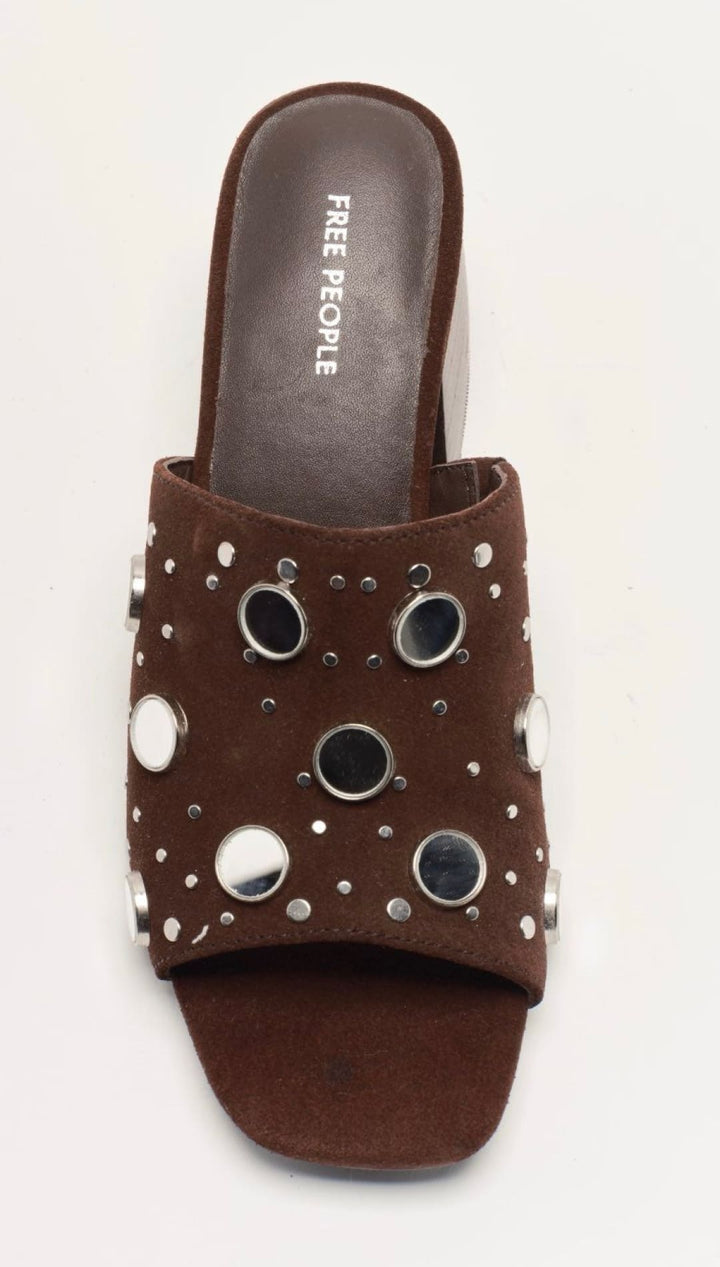 Brown free people slide sandal with silver eyelets and studs.