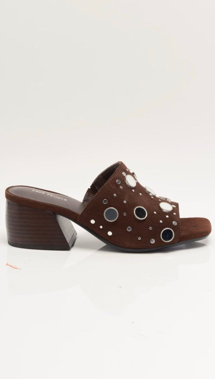 Brown leather clog with eyelet details and studded embellishments.