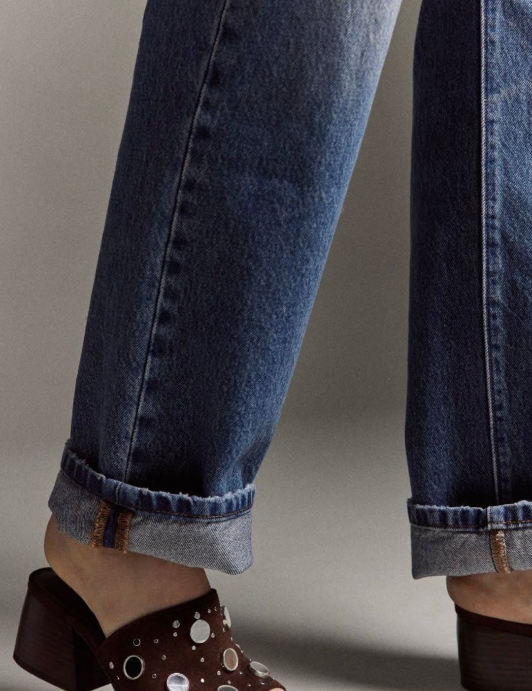 Brown polka dot mule sandal with buckle detail.