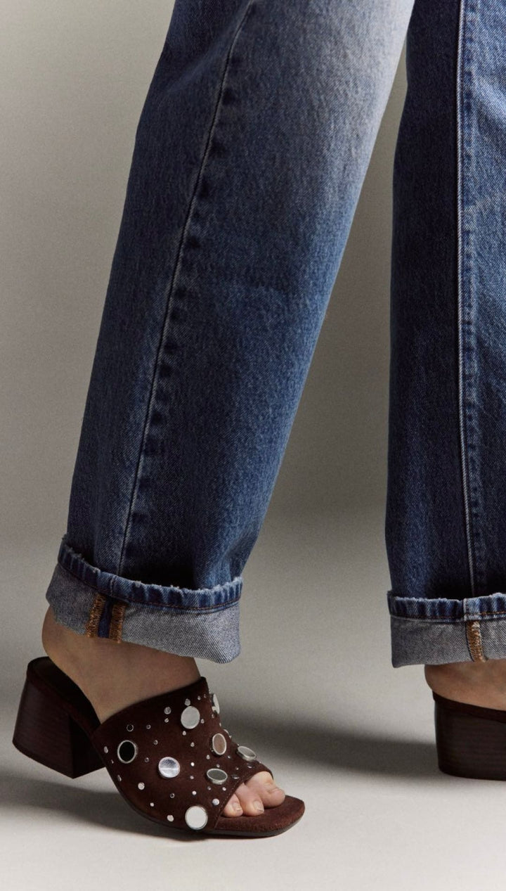 Brown polka dot mule sandal with buckle detail.