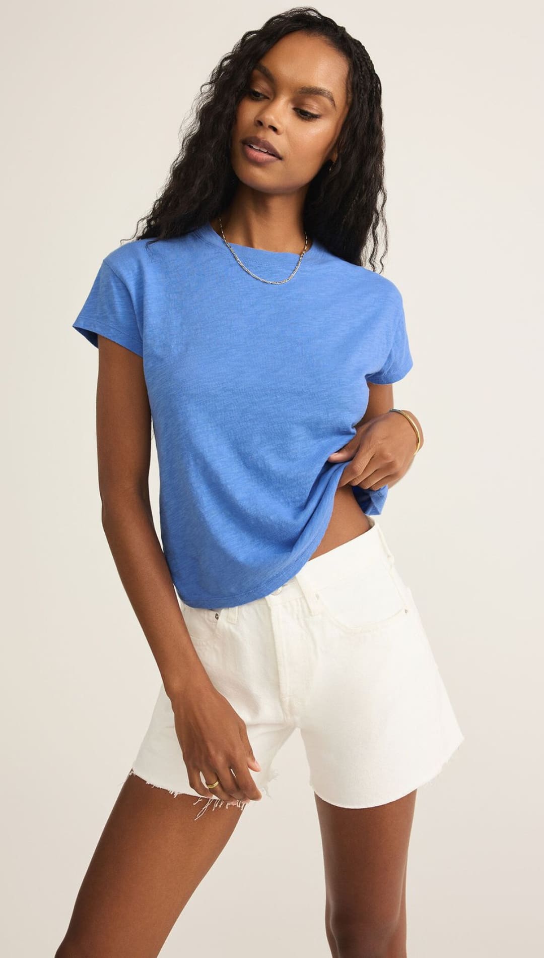 Woman in blue t-shirt and white shorts.