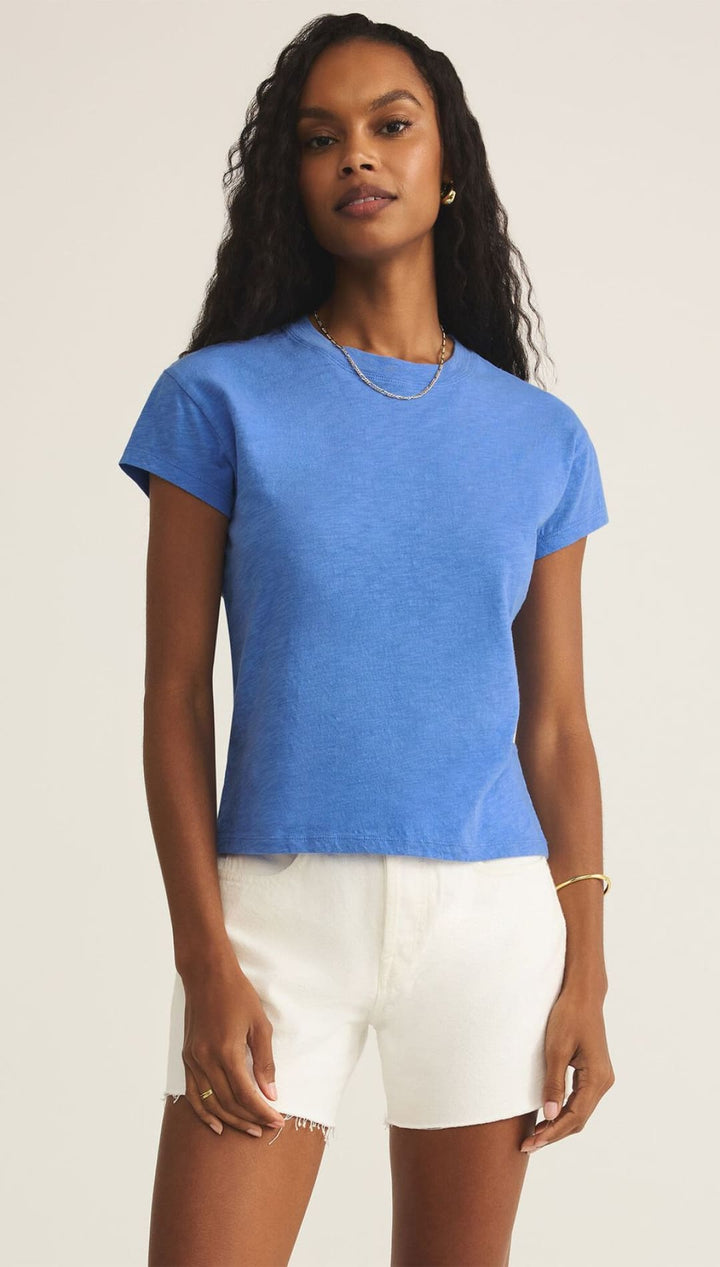 Woman in blue t-shirt and white shorts.
