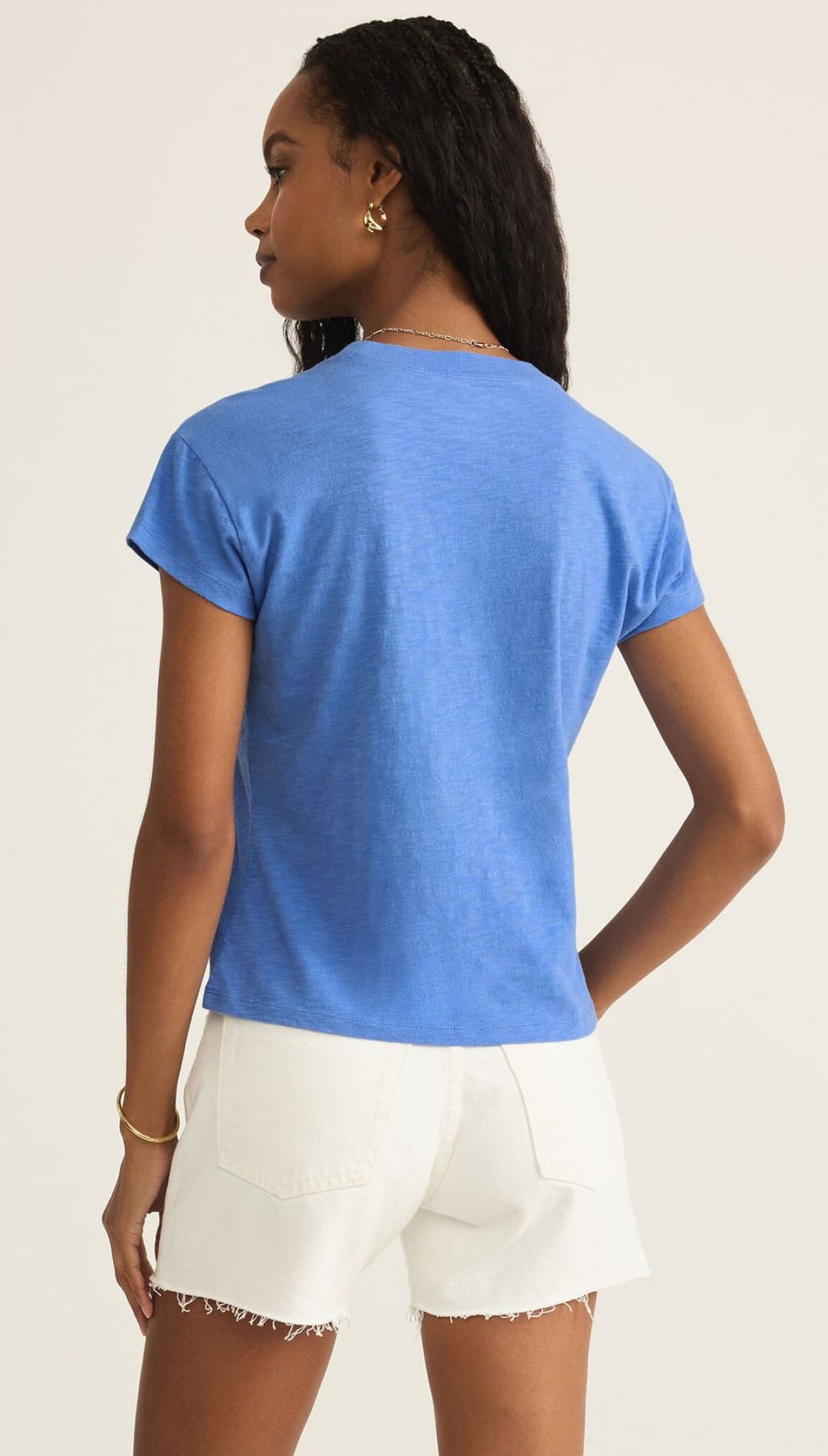 Woman in blue t-shirt and white shorts.