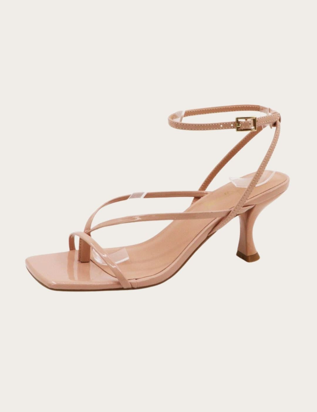 Nude-colored strappy heeled sandal.