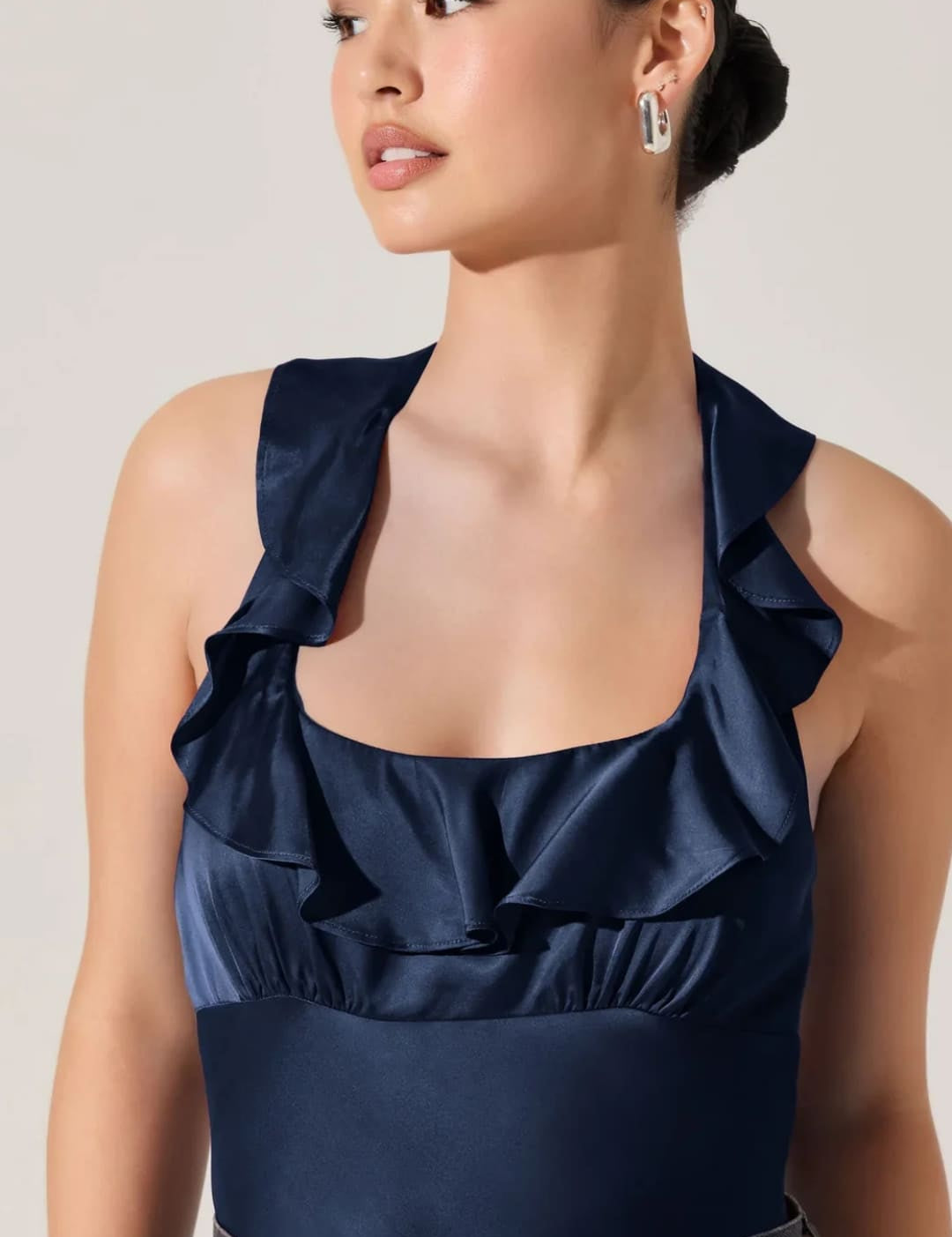 Navy blue satin ruffle-trim halter top.
