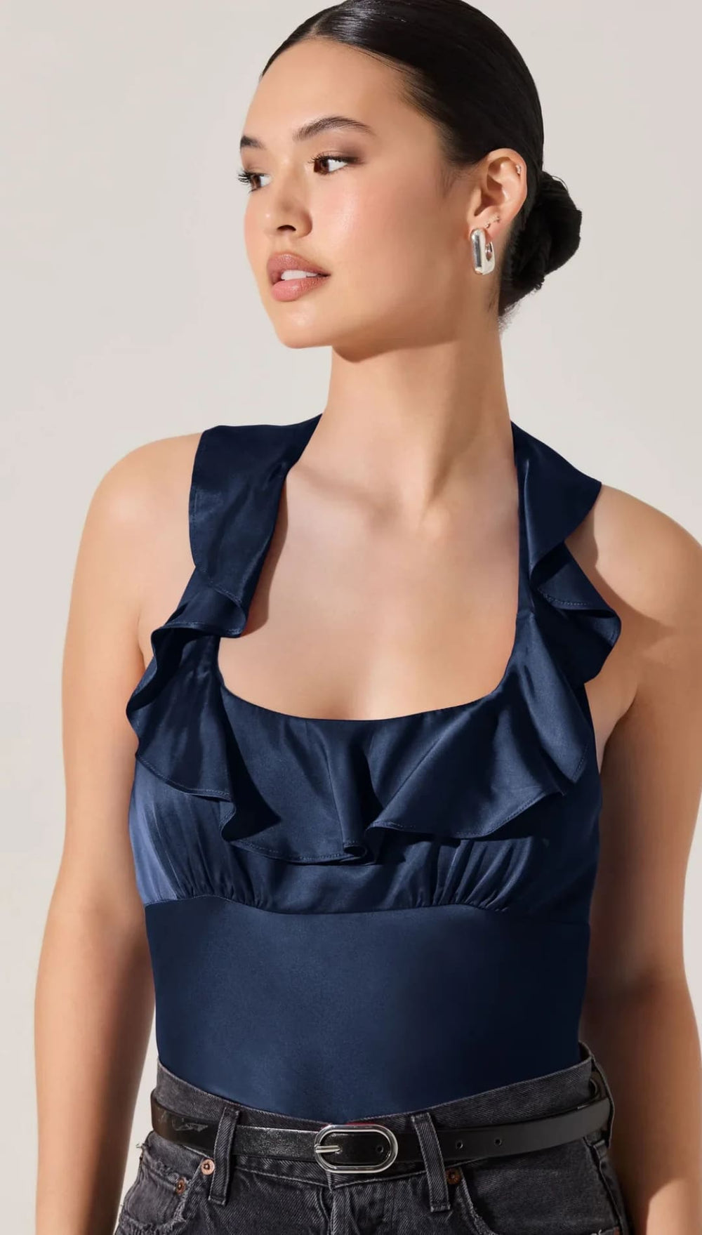 Navy blue satin ruffle-trim halter top.