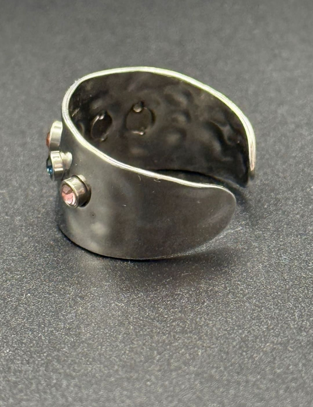 Silver ring with colorful gems.