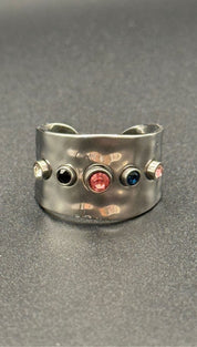 Silver ring with colorful gemstones.