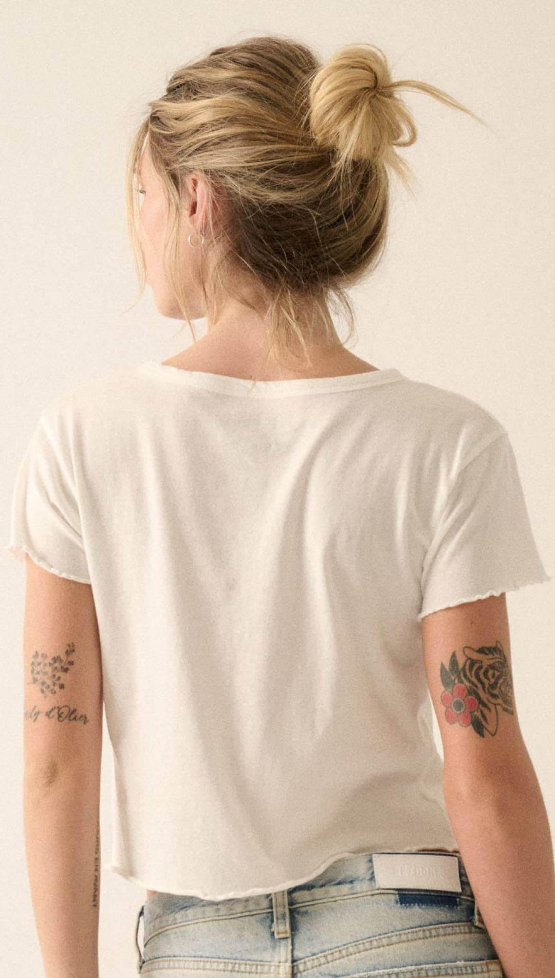 White cropped t-shirt with a soft, slightly faded cotton texture and relaxed fit.