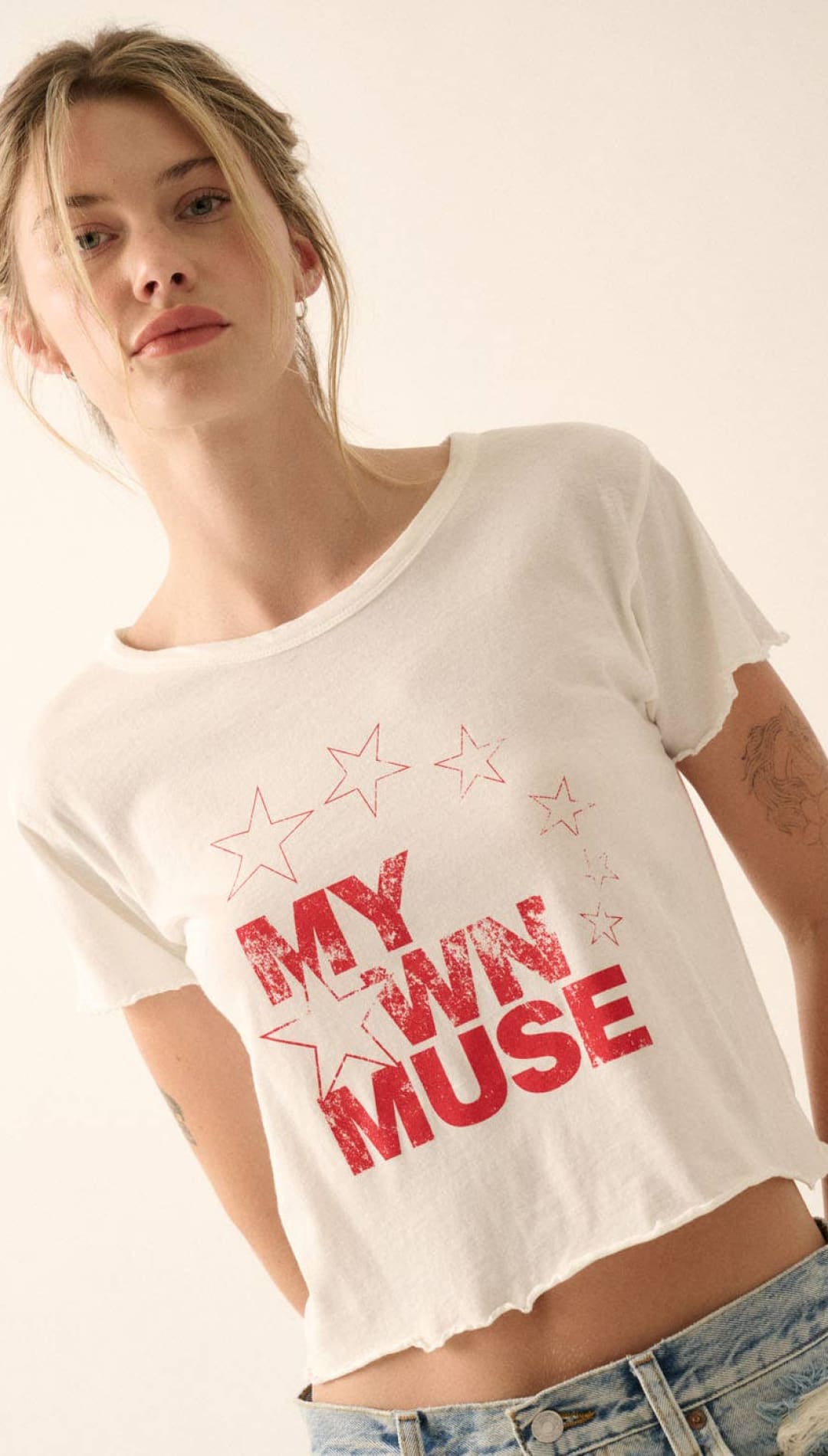 White cropped t-shirt with red ’my own muse’ graphic and star outlines