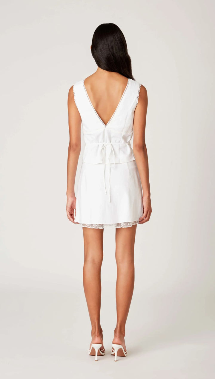 White mini dress with lace trim.