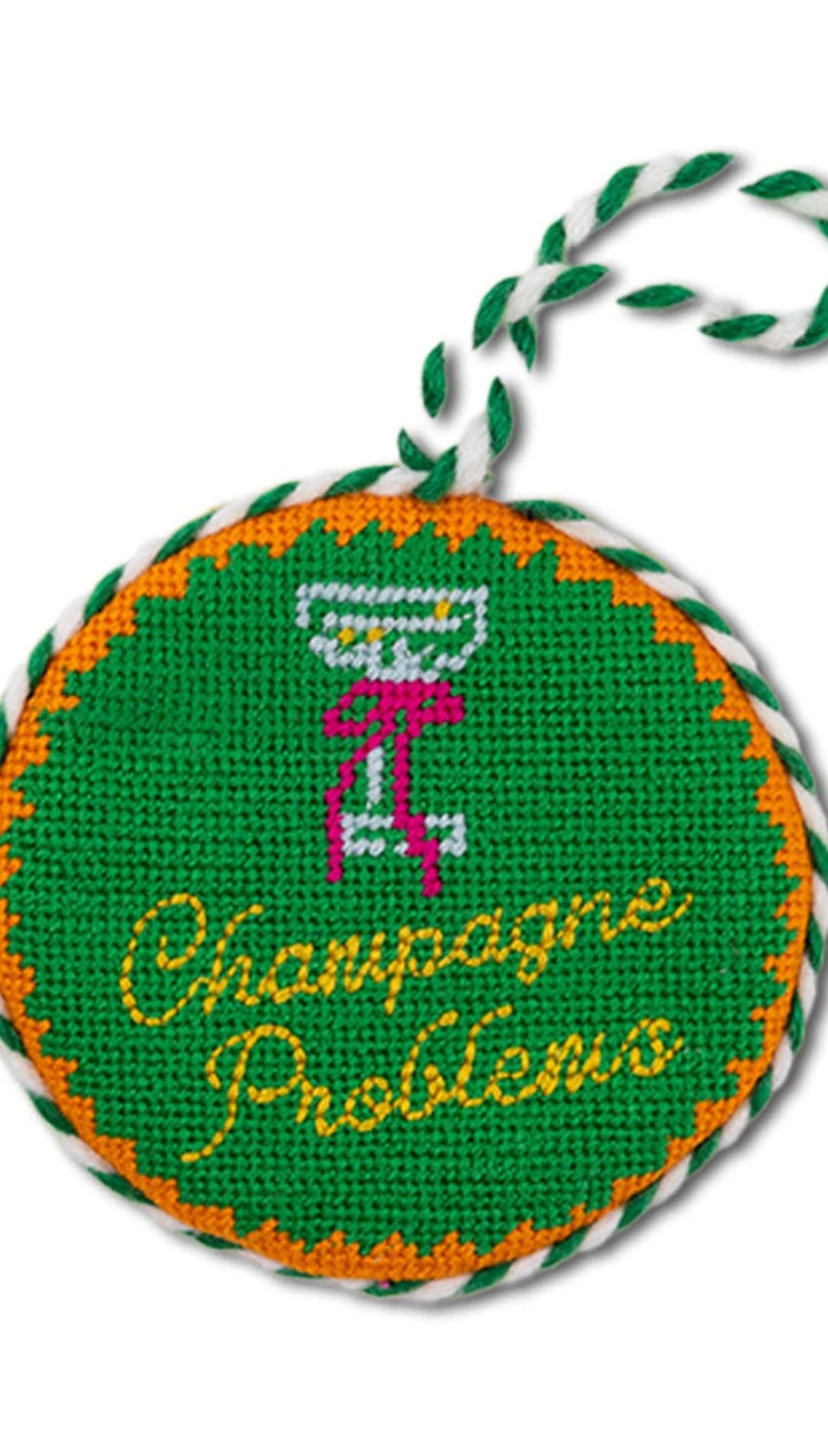 Champagne problems needlepoint ornament with green and orange accents, white rope hanger.
