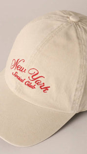 Beige cotton baseball cap with red embroidered ’new york social club’ script.