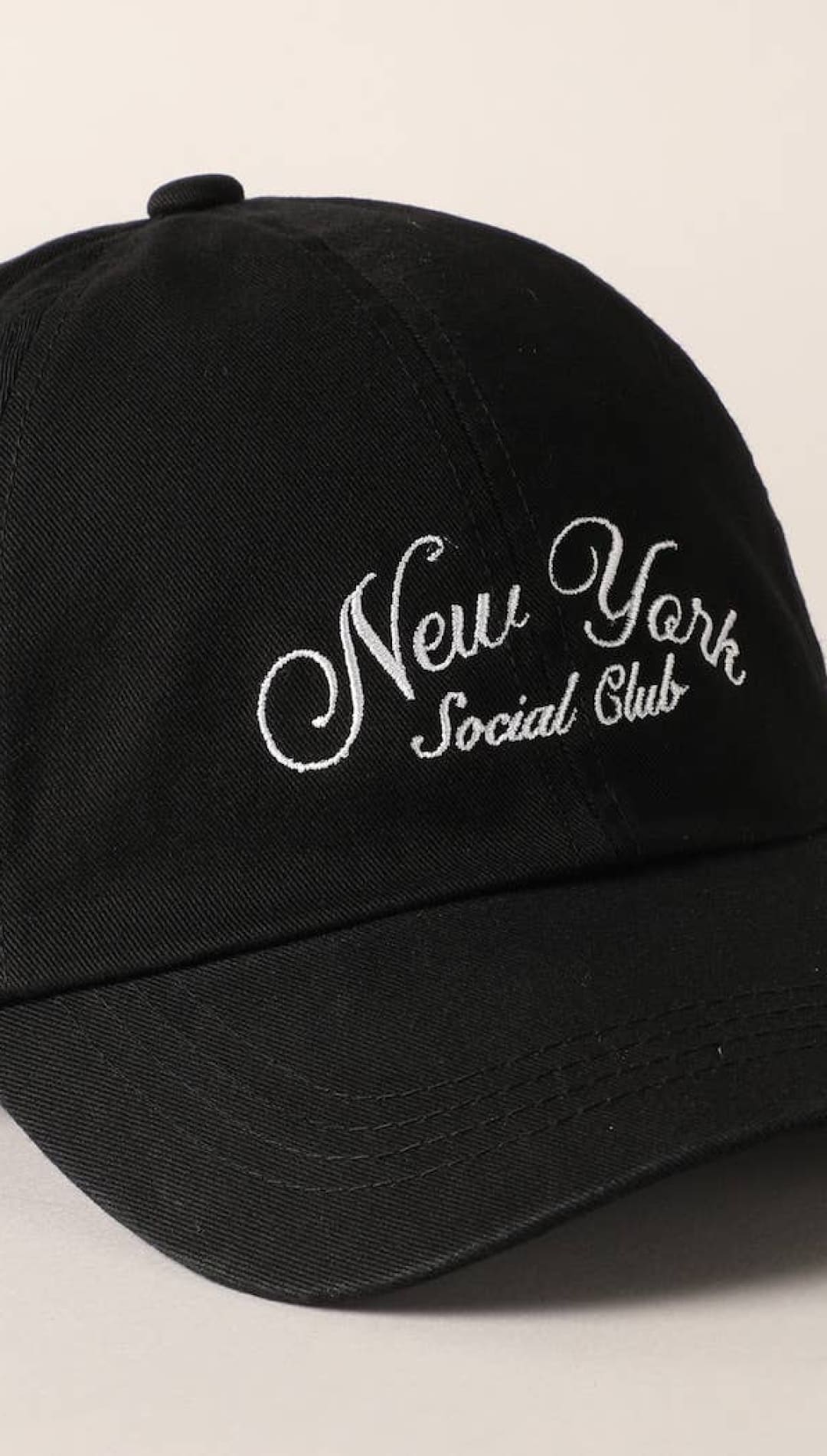 Black cotton baseball cap with white embroidered ’new york social club’ script.