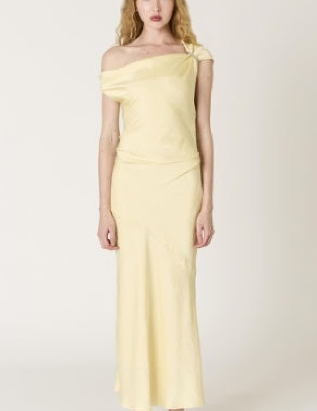 A pale yellow satin off-the-shoulder maxi dress with a sleek, flowing silhouette.