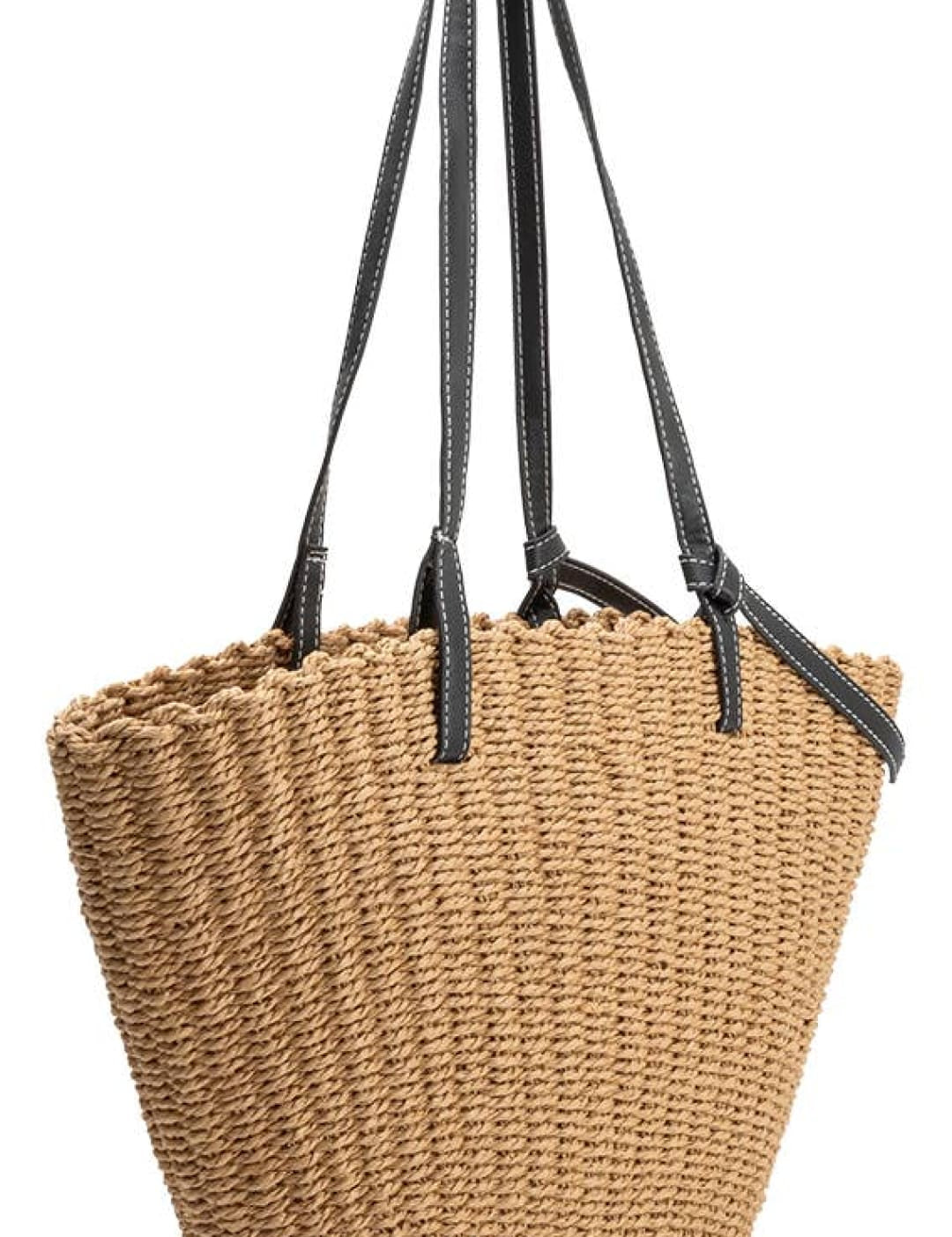 Beige woven straw tote bag with black leather straps.