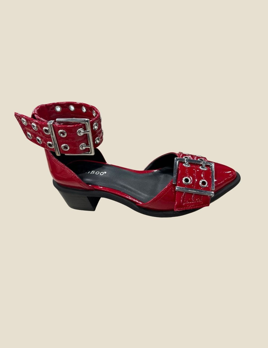 Red patent leather Mary Jane-style flats with multiple silver buckles and eyelets.