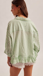 Light green and white vertically striped cotton blouse with ruffled hem.