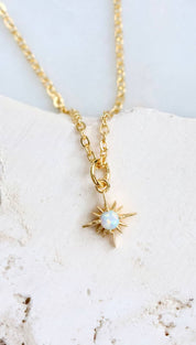 Gold starburst pendant necklace.