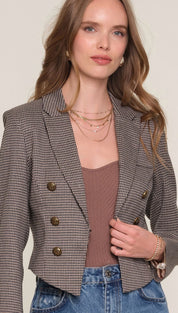 Brown and white checkered blazer with double-breasted buttons.